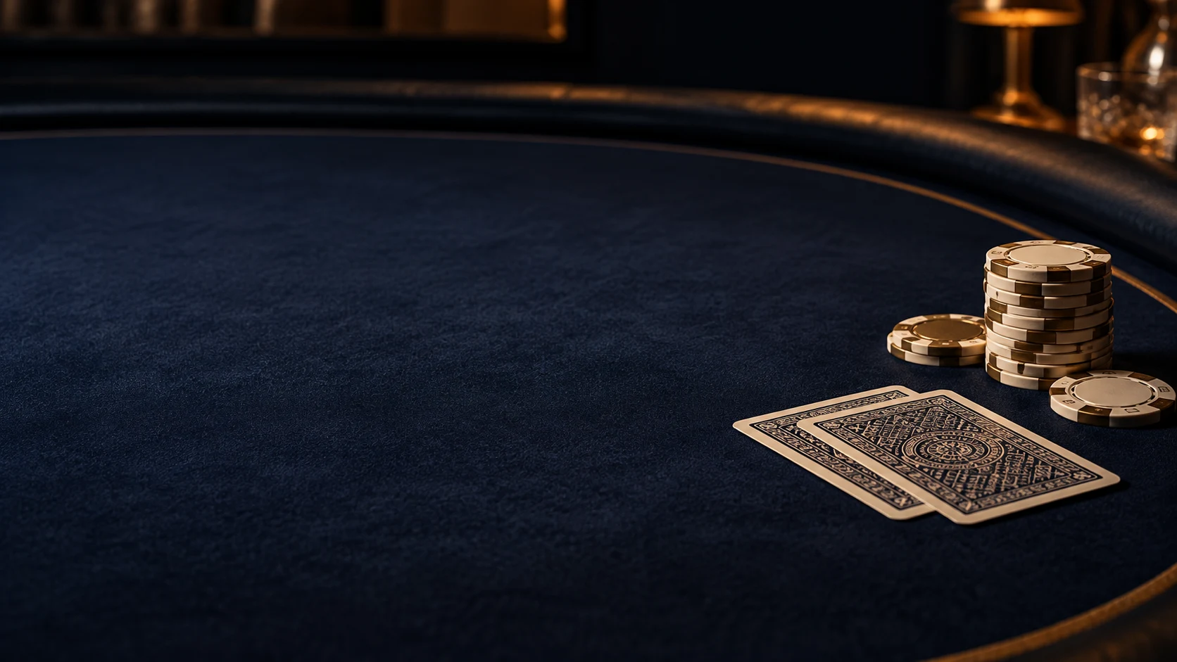 Poker chips and face-down cards beside a quiet playing surface